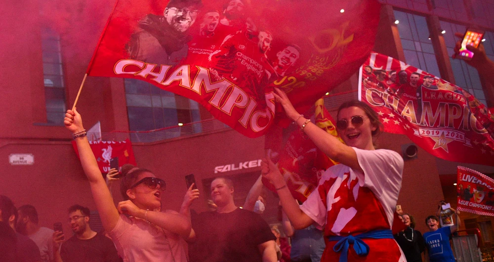 Fans celebrate Liverpool winning the championship title of the English Premier League. (AFP)