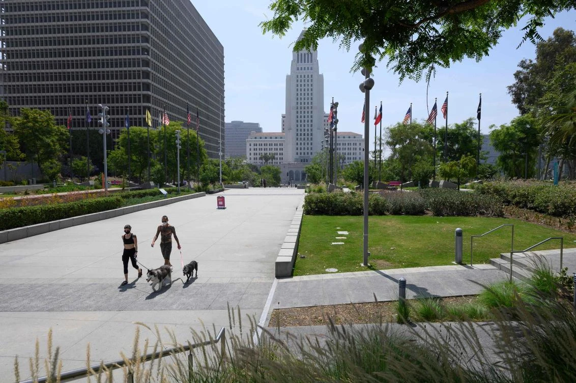 People walk in Grand Park with Los Angeles City Hall seen in the background. (AFP)
