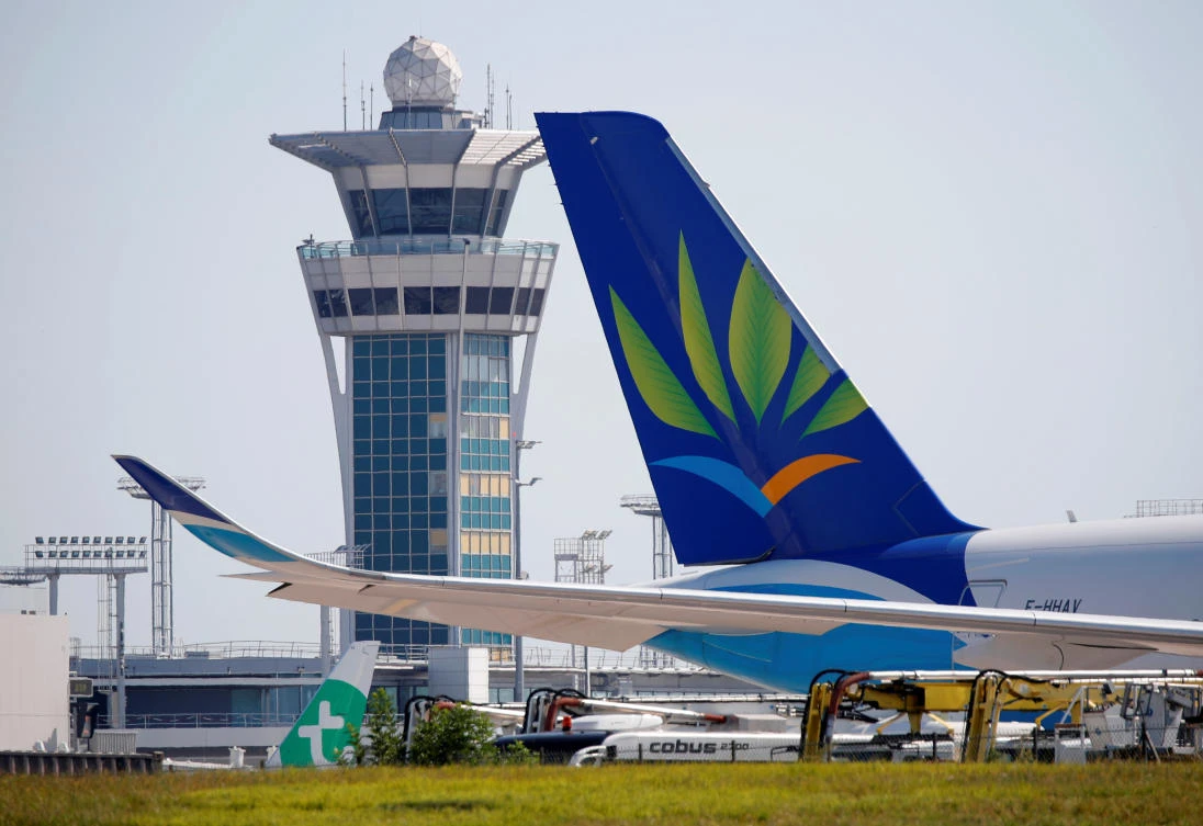 The tail fin of a Air caraibes passenger Airbus A350 aircraft is seen near the control tower at Orly Airport before for its re-opening following the coronavirus disease (COVID-19) outbreak in France, June 24, 2020. (Reuters)