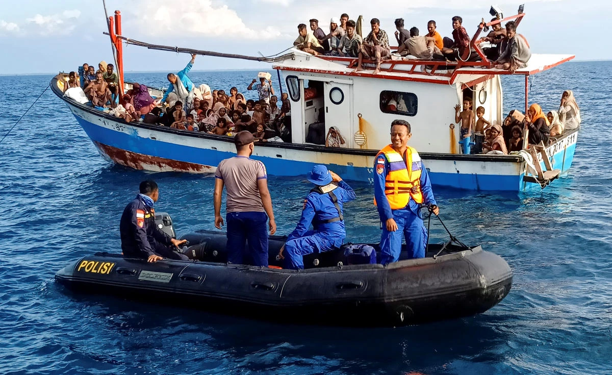 The Rohingya refugees rescued by fishermen are seen on a boat behind a patrol boat near the coast of Seunuddon beach in North Aceh, Indonesia, June 24, 2020. (Reuters)