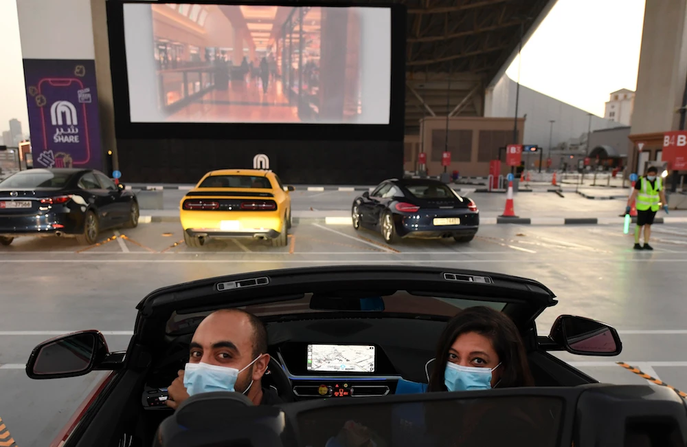 Passengers watch a movie from their car at a drive-in cinema outside the Mall of Emirates in Dubai on May 17, 2020, during the COVID-19 pandemic. (AFP/File Photo)