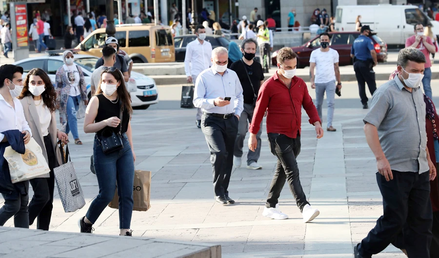 People wear protective face masks against to curb the spread of the novel coronavirus (COVID-19) in Kizilay Square, in Ankara on June 24, 2020. (AFP)