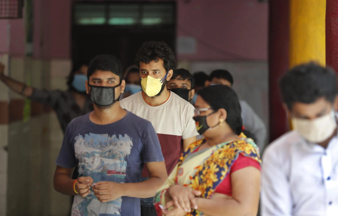 People wait in a queue for the COVID-19 rapid antigen test in New Delhi, India, Wednesday, June 24, 2020. (AP)