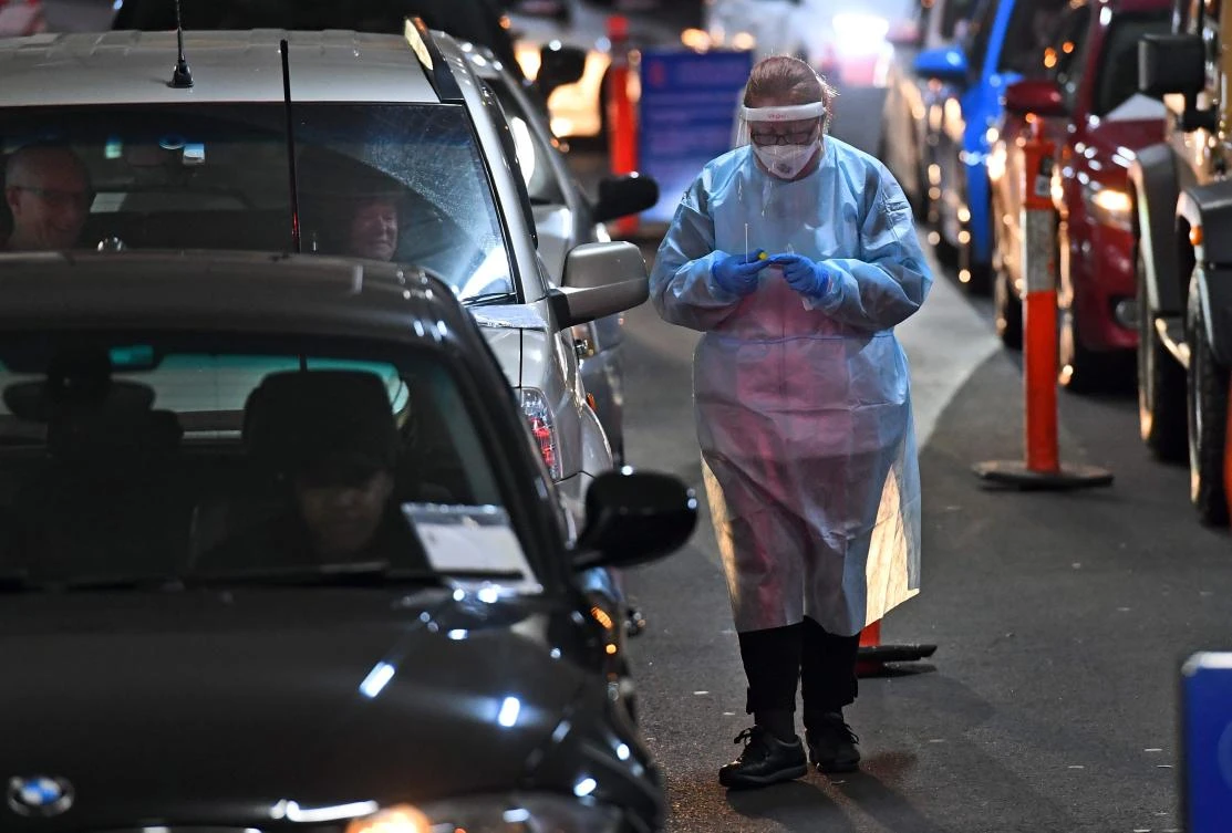 A medical staff member works at a drive-through COVID-19 coronavirus testing site in a shopping center carpark in Melbourne on June 26, 2020. (AFP)