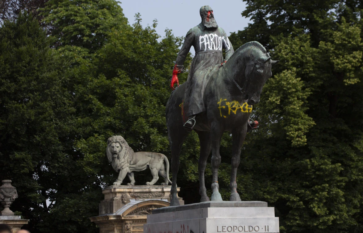 In this Wednesday, June 10, 2020 file photo, a statue of Belgium's King Leopold II is smeared with red paint and graffiti in Brussels. Five mixed-race women born in Congo when the country was under Belgian rule who were taken away from their Black mothers have filed a lawsuit for crimes against humanity targeting the Belgian state. (AP)