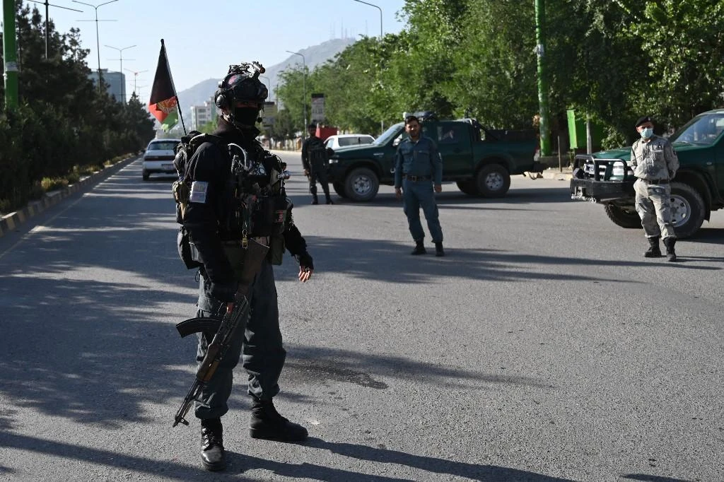 Above, security personnel man a checkpoint in Kabul on May 24, 2020. (AFP file photo)