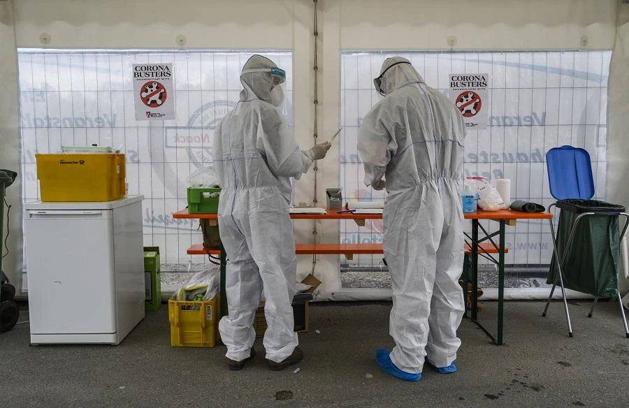Health professionals wearing protective gear, face shield and face mask prepare a testing kit at a drive-in COVID-19 testing facility in Berlin on April 30, 2020. (File/AFP)