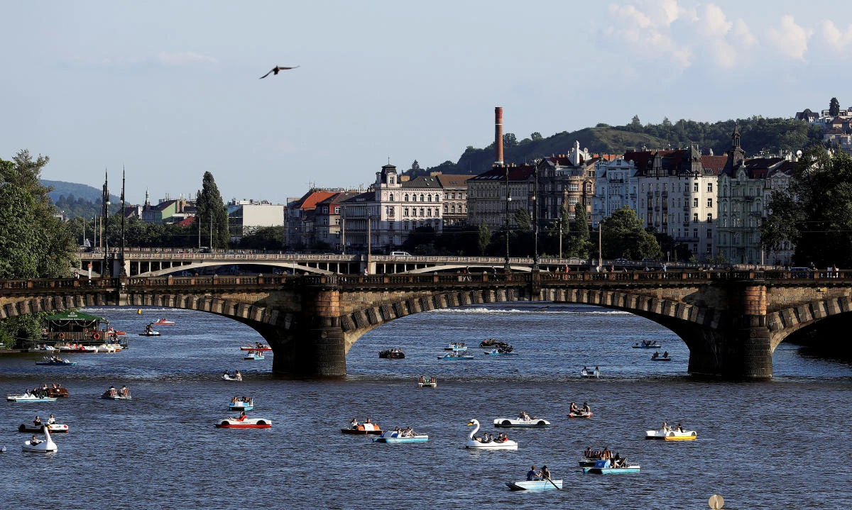 People ride pedal boats on the Vltava river following the coronavirus disease (COVID-19) outbreak, in Prague, Czech Republic, June 22, 2020. (Reuters)