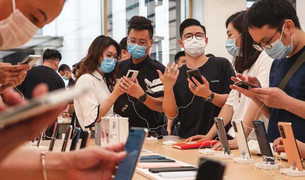Customers look at Huawei smartphones at a flagship store in Shanghai. Huawei plans to strengthen the brand in its core domestic market. (AFP)