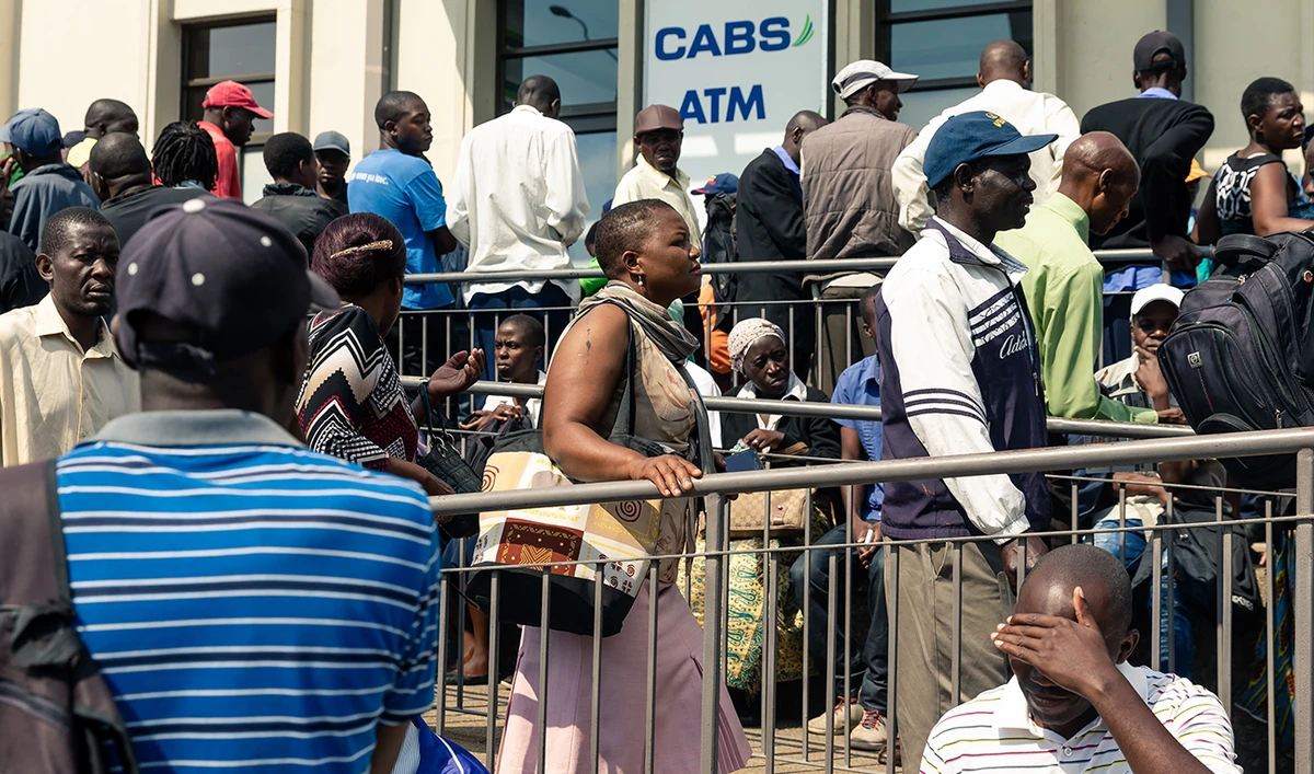 In this file photo taken on November 12, 2019 Customers, some of whom slept overnight in the queue, wait outside a bank the release of a new Zimbabwean currency in Harare on November 12, 2019. Zimbabwe is buffeted by its worst economic crisis in over a decade including scarcity of basics like the staple cornmeal, galloping prices of basic goods as the value of Zimbabwean dollars continues to fast depreciate. (AFP)
