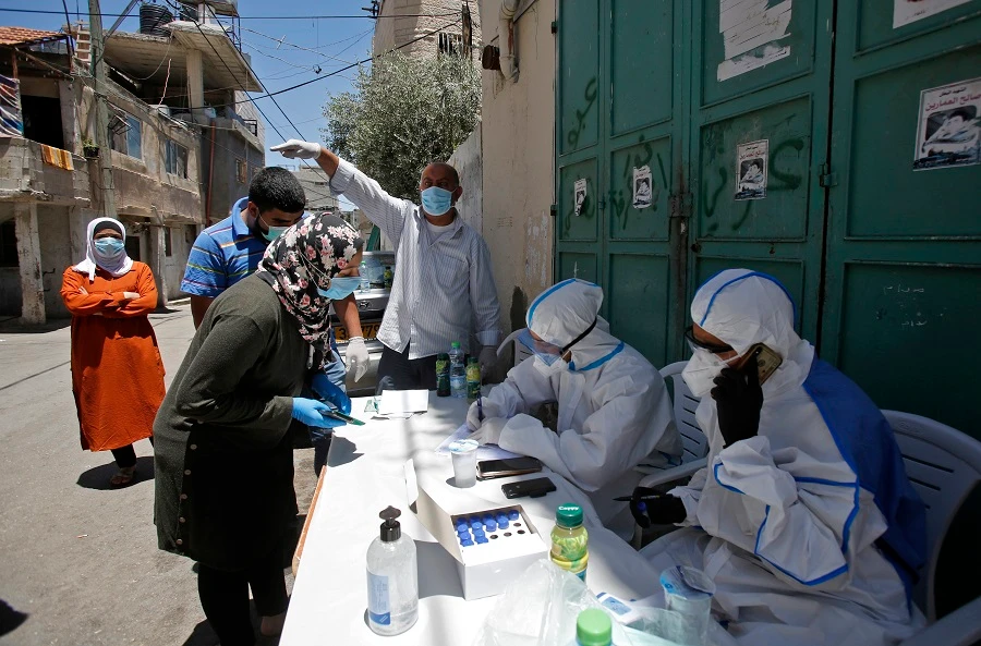 The ministers issued on Sunday a statement calling for collective action to help Palestinian authorities in the face of the pandemic. (File/AFP)