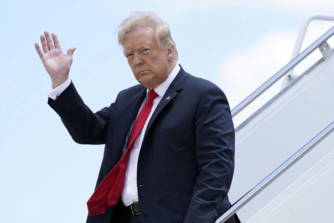 In this Thursday, June 25, 2020 file photo, President Donald Trump waves as he arrives on Air Force One at Austin Straubel International Airport in Green Bay, Wis. (AP)