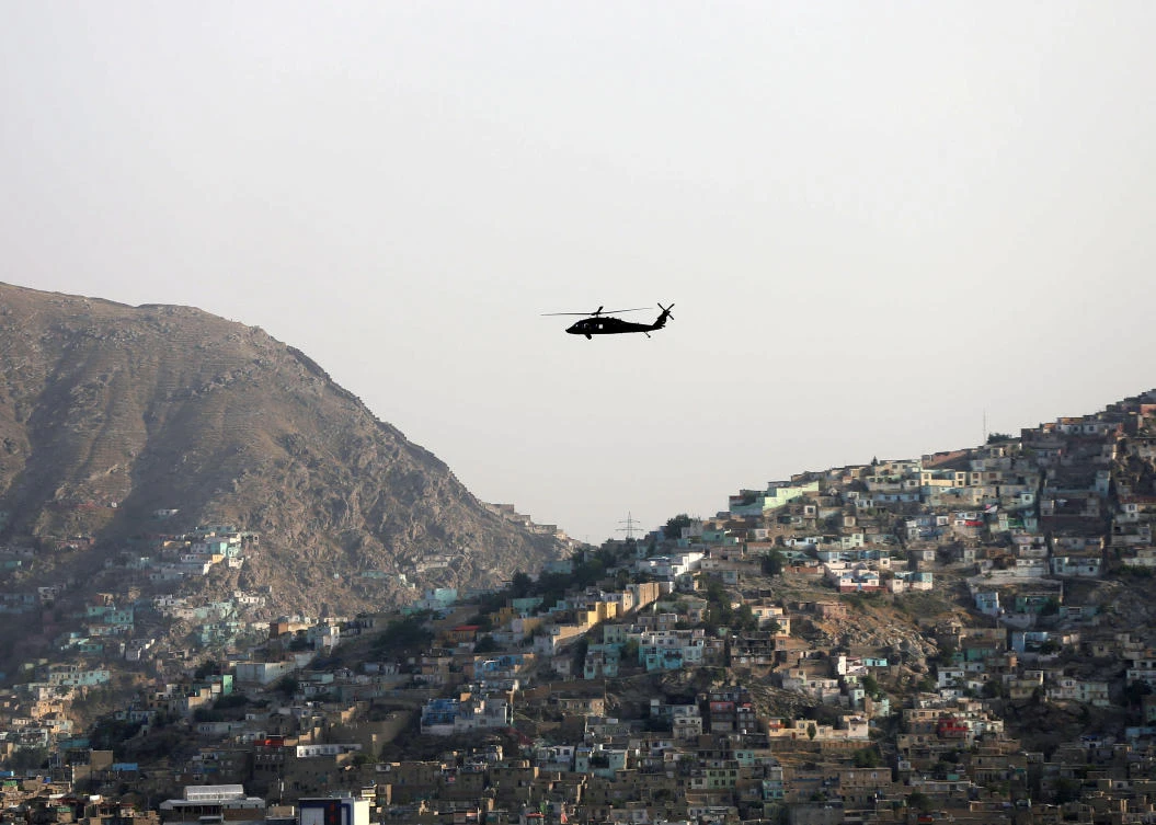 A NATO helicopter flies over the city of Kabul, Afghanistan June 29. 2020. (Reuters)