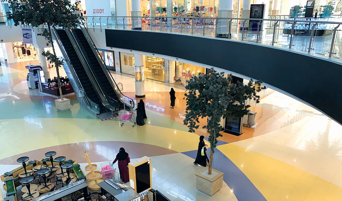 Women shop in a largely deserted Hayat mall in Riyadh during the lockdown. The Kingdom’s economy will shrink by 6.8 percent, according to the IMF. (AFP)