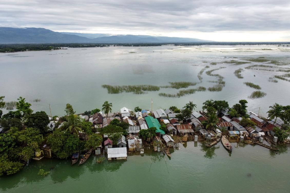This aerial view shows flooded houses in Sunamganj on July 15, 2020. Almost four million people have been hit by monsoon floods in South Asia, officials said July 14, with a third of Bangladesh already underwater from some of the heaviest rains in a decade. / AFP / Munir Uz zaman