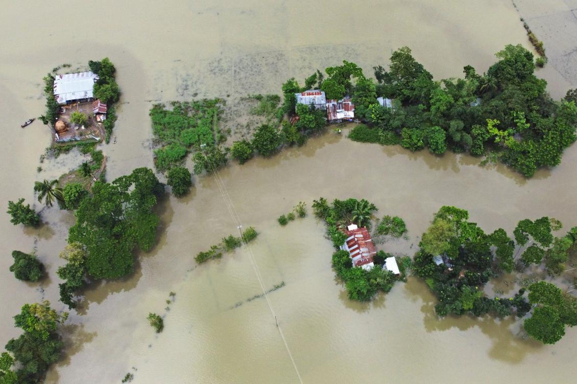 In this aerial photo inundated houses are seen in Sunamgong on July 15, 2020. Almost four million people have been hit by monsoon floods in South Asia, officials said on July 14, with a third of Bangladesh already underwater from some of the heaviest rains in a decade. / AFP / Munir UZ ZAMAN