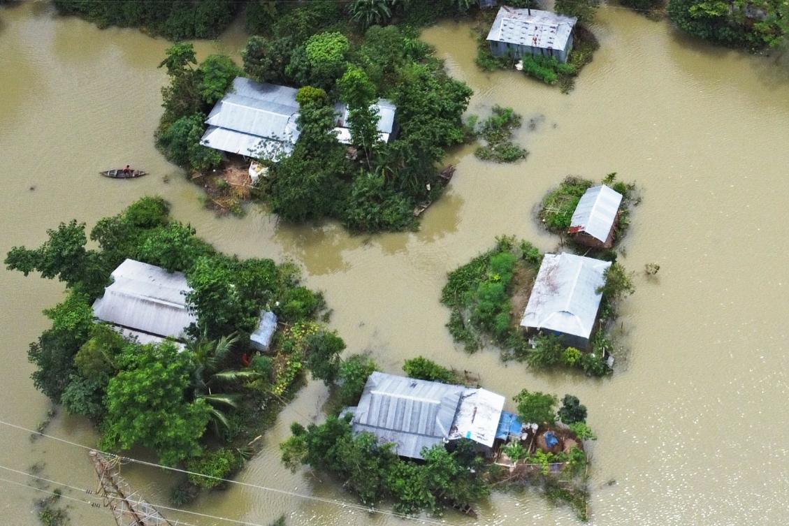 In this aerial photo inundated houses are seen in Sunamgong on July 15, 2020. Almost four million people have been hit by monsoon floods in South Asia, officials said on July 14, with a third of Bangladesh already underwater from some of the heaviest rains in a decade. / AFP / Munir UZ ZAMAN