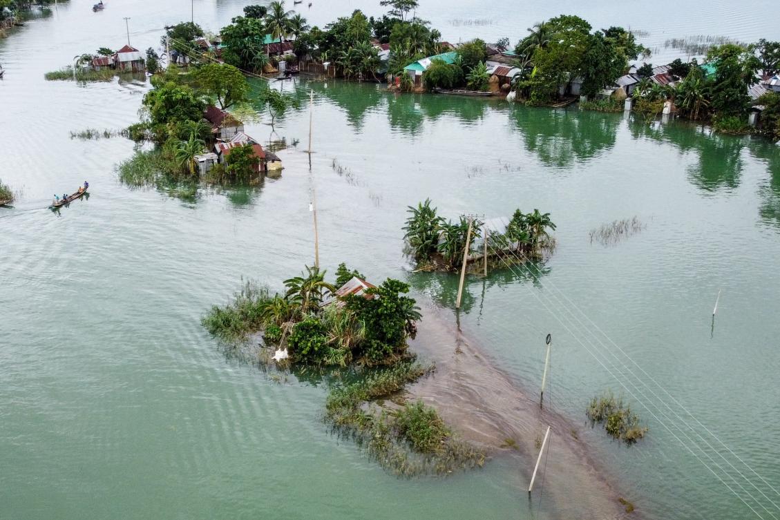 This aerial view shows flooded houses in Sunamganj on July 15, 2020. Almost four million people have been hit by monsoon floods in South Asia, officials said July 14, with a third of Bangladesh already underwater from some of the heaviest rains in a decade. / AFP / Munir Uz zaman