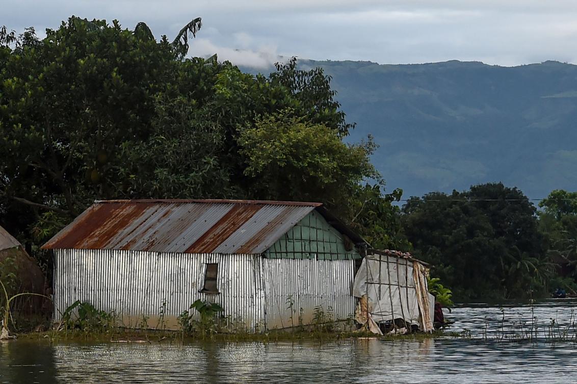 A house is seen under floodwaters in Sunamganj on July 15, 2020. Almost four million people have been hit by monsoon floods in South Asia, officials said July 14, with a third of Bangladesh already underwater from some of the heaviest rains in a decade. / AFP / Munir Uz zaman
