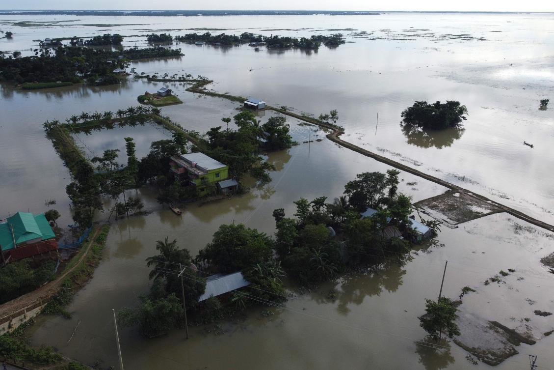 In this aerial photo inundated houses are seen in Sunamgong on July 14, 2020. Almost four million people have been hit by monsoon floods in South Asia, officials said July 14, with a third of Bangladesh already underwater from some of the heaviest rains in a decade. / AFP / Munir UZ ZAMAN