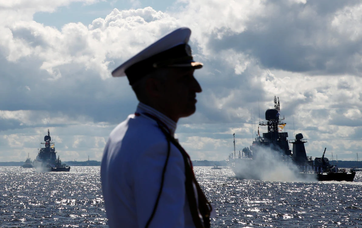 A Russian Navy officer stands on the embankment as warships sail during the Navy Day parade in Kronstadt near Saint Petersburg, Russia July 26, 2020. REUTERS/Anton Vaganov/Pool