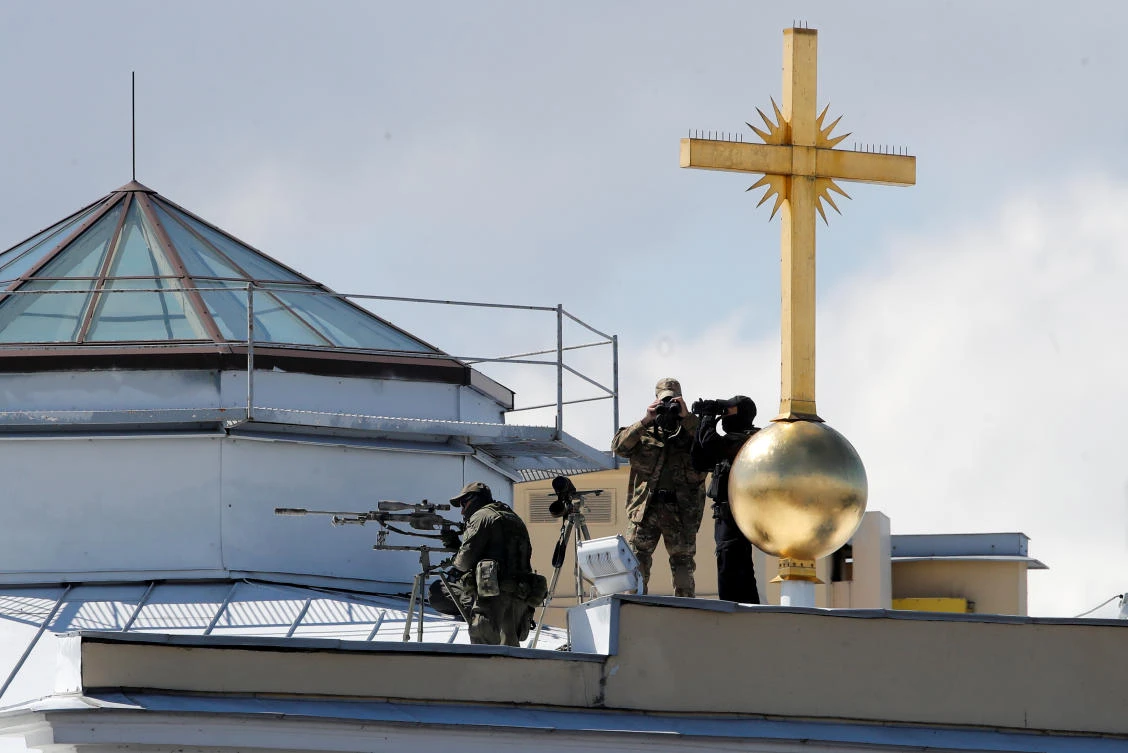 A security service officer aims his sniper rifle securing the area ahead of the Navy Day parade in Saint Petersburg, Russia July 26, 2020. Dmitri Lovetsky/Pool via REUTERS