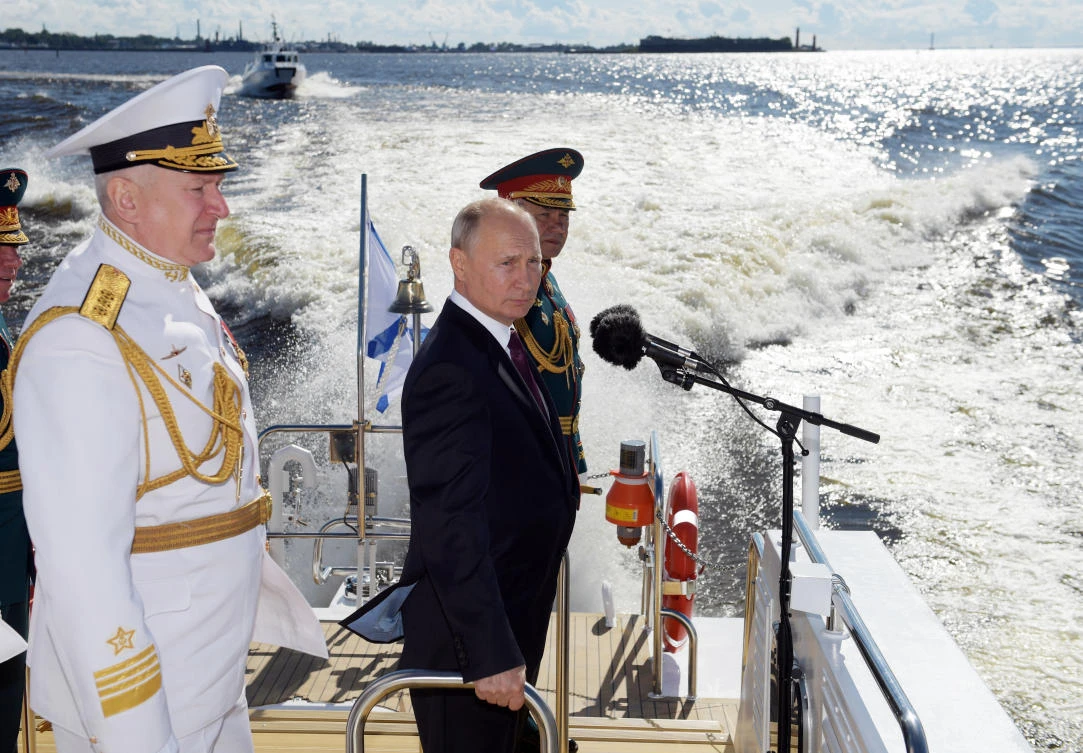 President Vladimir Putin, center, Admiral Nikolai Yevmenov, Commander-in-Chief of the Russian Navy, left, and Russian Defence Minister Sergei Shoigu inspect warships during the Navy Day parade in St.Petersburg, Russia, on Sunday, July 26, 2020. (Alexei Druzhinin, Sputnik, Kremlin Pool Photo via AP)
