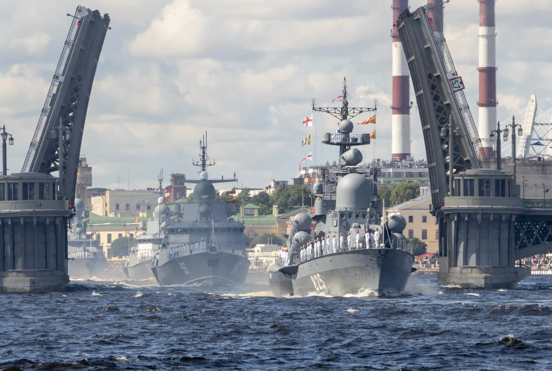 Warships pass the Blagoveschensky drawbridge rising above the Neva River during the Navy Day parade in St.Petersburg, Russia, Sunday, July 26, 2020.(AP Photo/Dmitri Lovetsky, Pool)