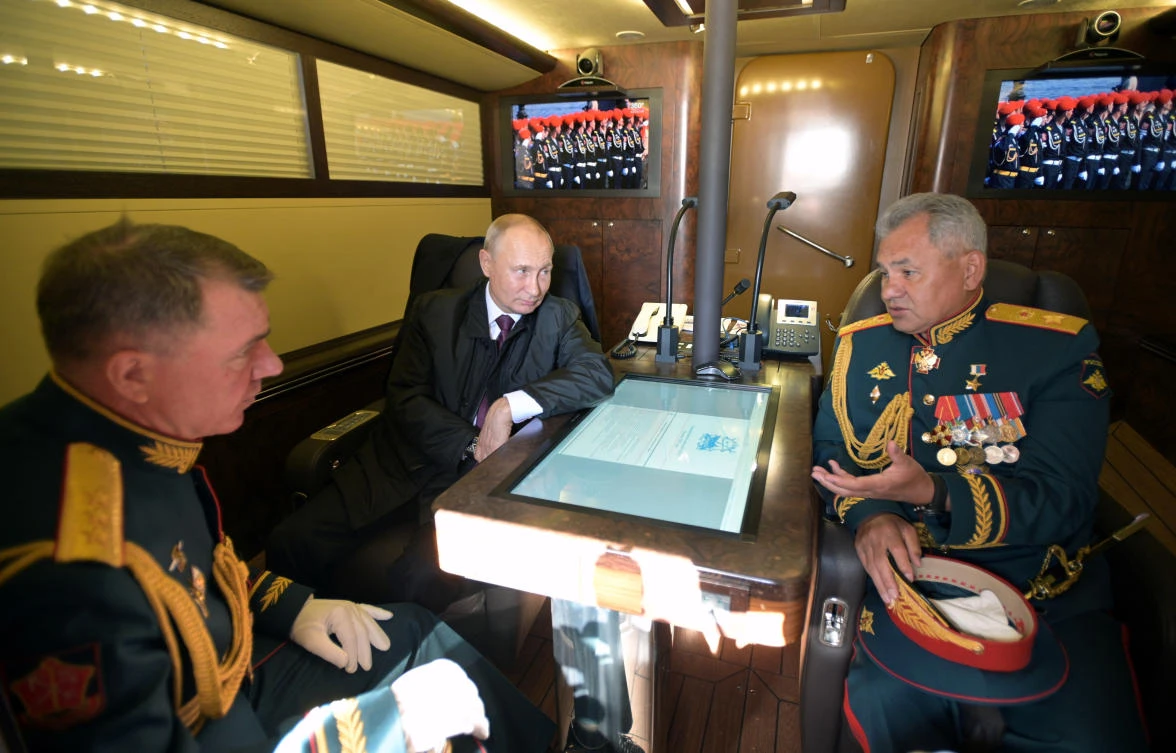 Russian President Vladimir Putin, Defence Minister Sergei Shoigu and Commander of the Western Military District of Russian Armed Forces Alexander Zhuravlyov are pictured aboard the Raptor patrol boat before the Navy Day parade in Saint Petersburg, Russia July 26 ,2020. Sputnik/Alexei Druzhinin/Kremlin via REUTERS ATTENTION EDITORS - THIS IMAGE WAS PROVIDED BY A THIRD PARTY.