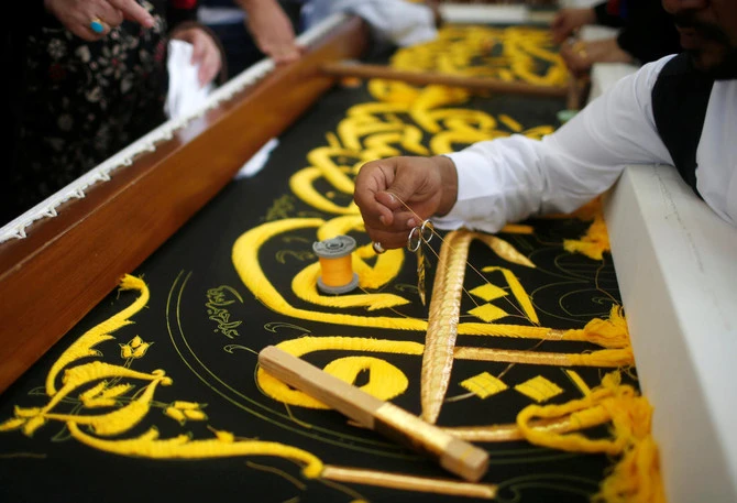 A man embroiders the Kiswa, a silk cloth covering the Holy Kaaba, ahead of the annual haj pilgrimage, at a factory in the holy city of Mecca, Saudi Arabia. .(REUTERS)