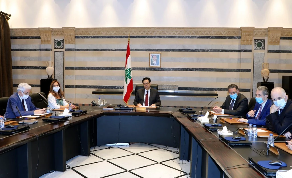 A handout picture provided by the Lebanese photo agency Dalati and Nohra on June 12, 2020 shows Prime Minister Hassan Diab (C) chairing an emergency cabinet session with other mask-clad ministers. (File/AFP)