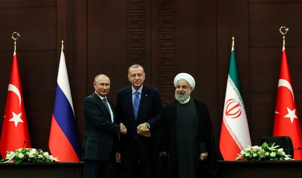 Turkish President Recep Tayyip Erdogan, center, Russian President Vladimir Putin, left, and Iranian President Hassan Rouhani after a trilateral meeting on Syria, in Ankara on September 16, 2019. (AFP)
