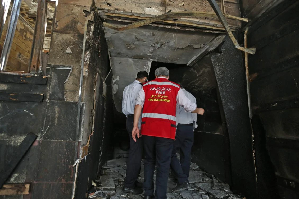 Iranian emergency staff inspect the site of an explosion at the Sina At'har health centre in the upmarket northern neighbourhood of Tajrish in the capital Tehran on July 1, 2020. (AFP)