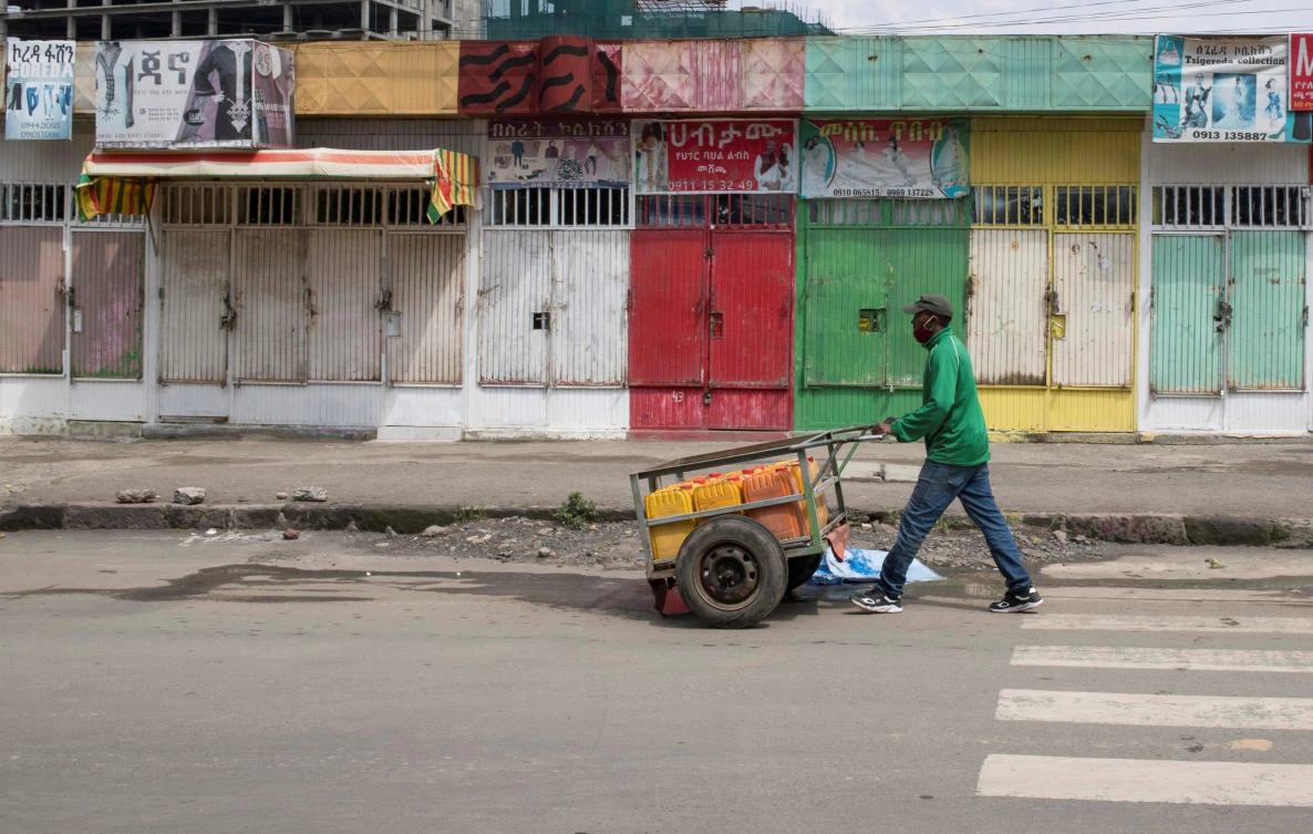 A man pushes a hand-cart past closed shops following protests in Addis Ababa, Ethiopia July 1, 2020. (Reuters)