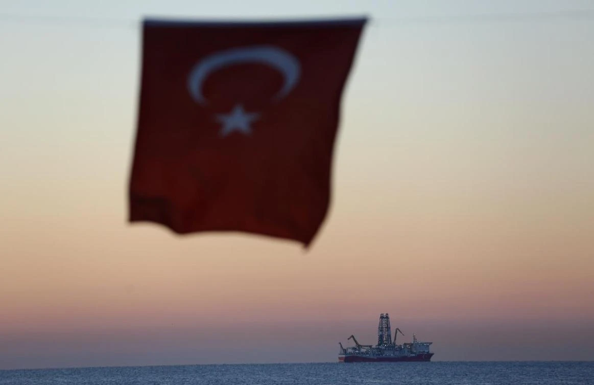 The Turkish national flag hangs in the foreground as drilling vessel Fatih is seen off the Mediterranean resort city of Antalya, Turkey October 30, 2018. (Reuters)