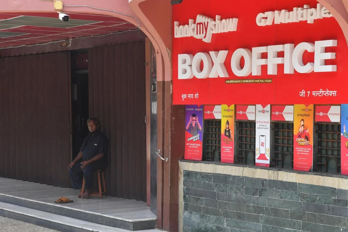 A security guard sits at the entrance of a closed movie theatre complex due to a COVID-19 coronavirus lockdown in Mumbai. (File/AFP)