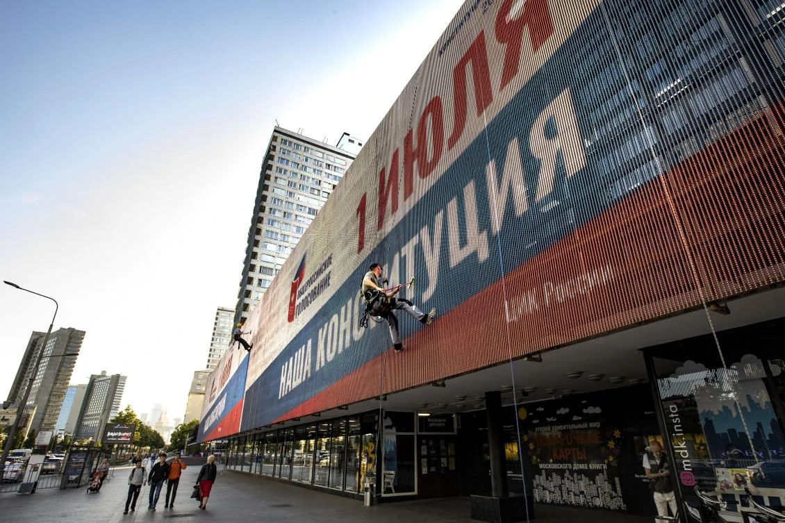 A worker cleans an electronic scoreboard reading ‘All-Russia voting, July 1, Our Constitution’ in Moscow on June 22, 2020. (AP)