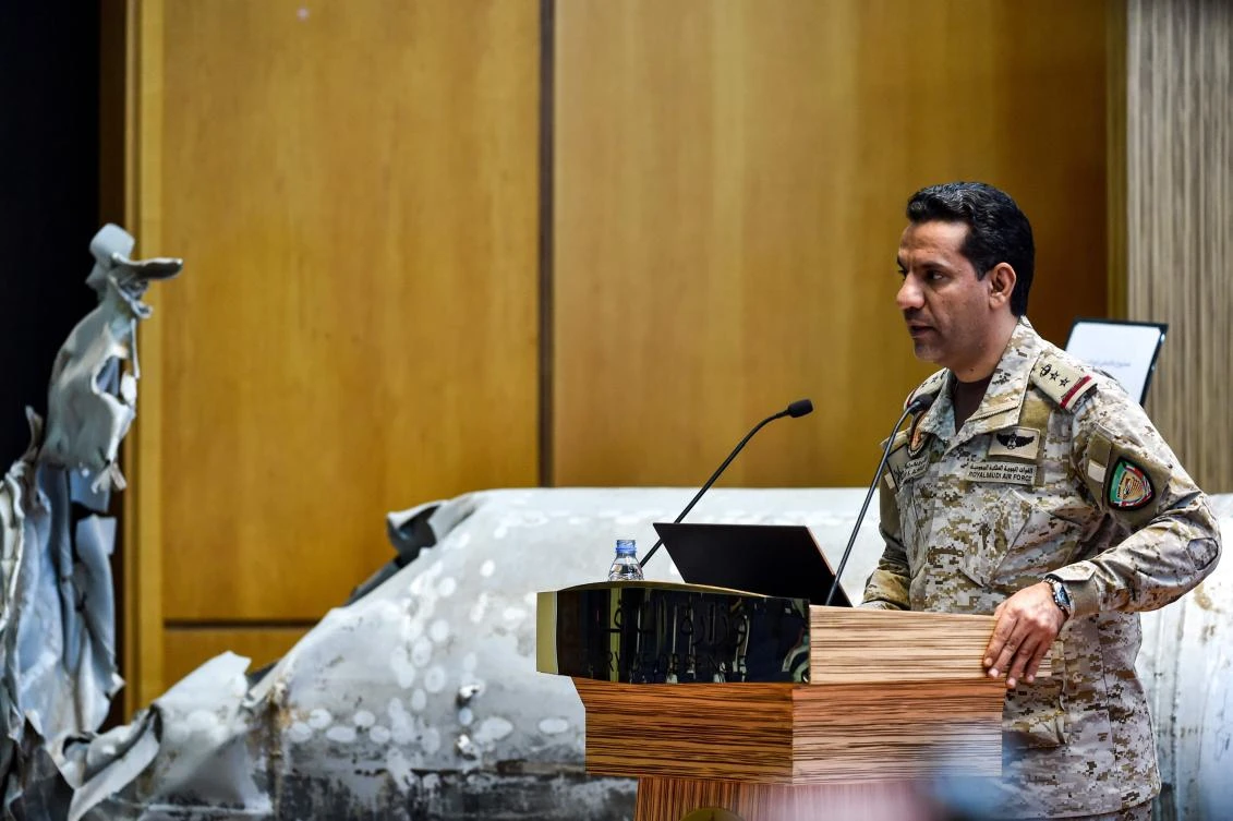 Arab coalition spokesperson Col. Turki Al-Maliki gives a press conference in Riyadh on July 2, 2020, alongside showcased alleged Iranian weapons seized from Yemen's Houthis. (AFP)