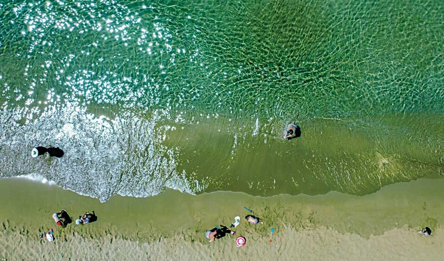 Greek island resorts are slowly welcoming back tourists after months of closure due to the coronavirus disease, with only a few months of holiday season left. (AFP)