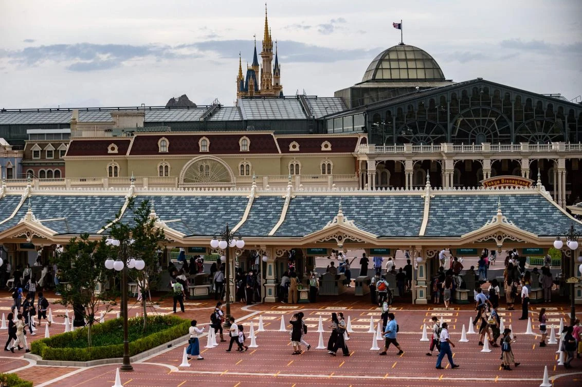 People arrive at Tokyo Disneyland during the reopening day of the park in Urayasu, near Tokyo on July 1, 2020. (AFP)
