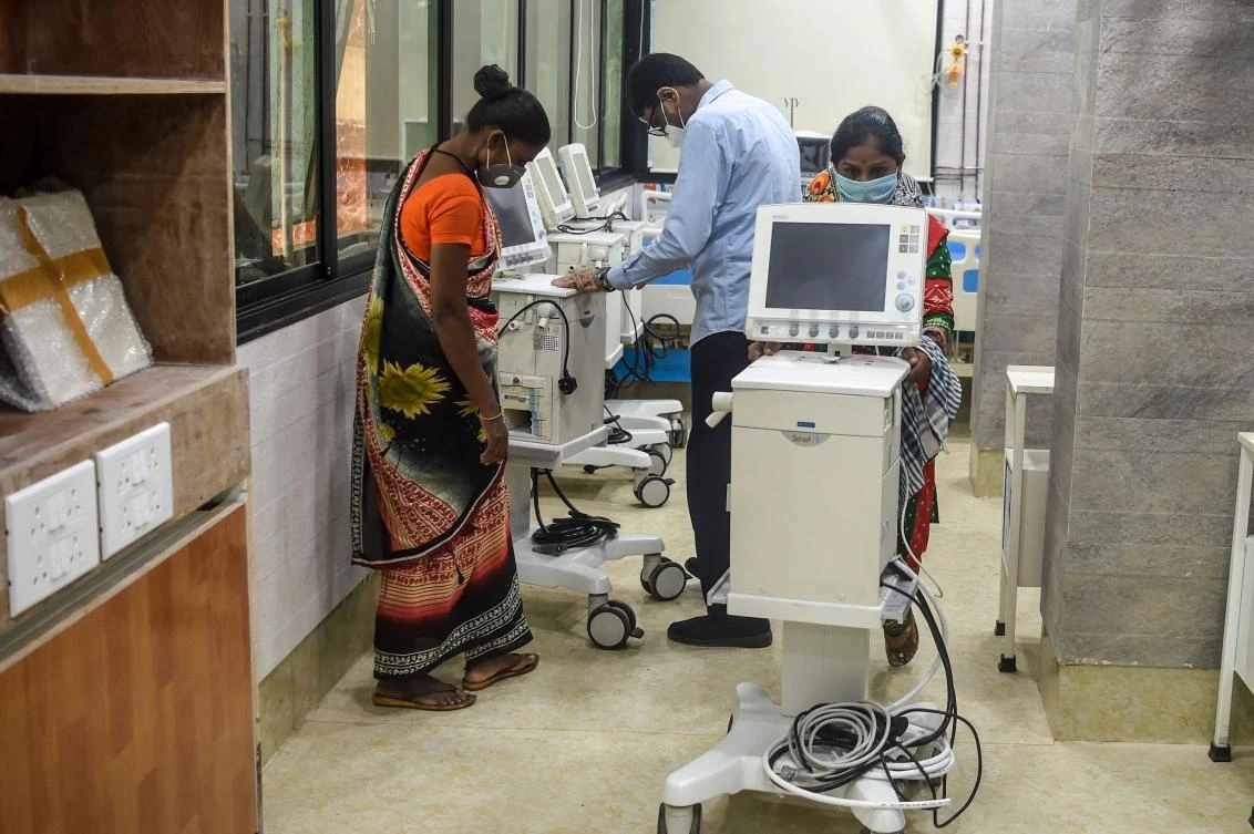 Workers arrange machines at a hospital recently set up for COVID-19 coronavirus patients in Mumbai on July 2, 2020. (AFP)