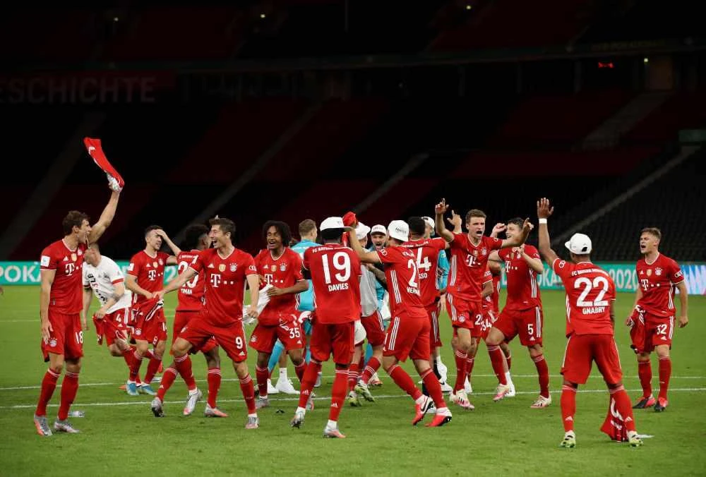 Bayern players celebrate after the German Cup (DFB Pokal) final football match Bayer 04 Leverkusen v FC Bayern Munich at the Olympic Stadium in Berlin on July 4, 2020. (AFP / POOL / Alexander Hassenstein)