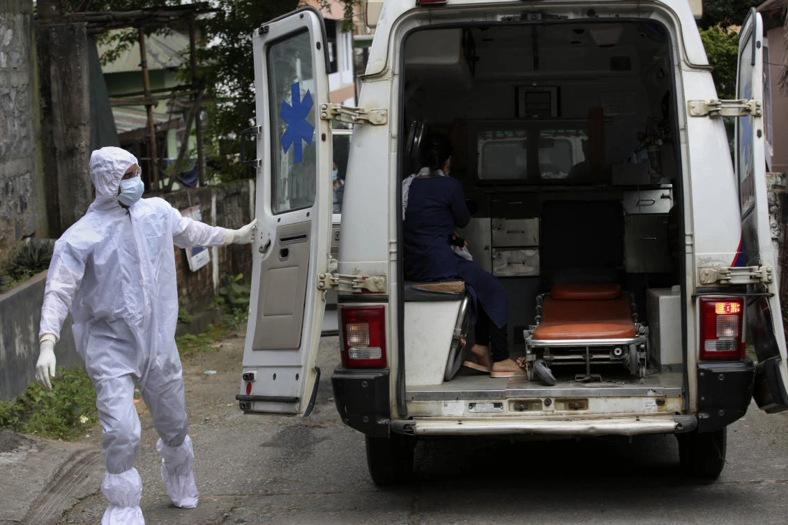 An Indian health worker closes the door of an ambulance after picking up a COVID-19 positive patient in Gauhati, India, Saturday, July 4, 2020. (AP)