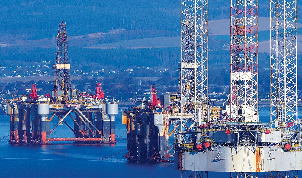 From left to right: Semi-submersible oil platforms, Ocean Princess and Ocean Nomad, and the self-elevating drilling unit GSF Galaxy III are seen in the Cromarty Firth from the village of Cromarty, north of Inverness, in the Highlands of Scotland. (AFP/File)
