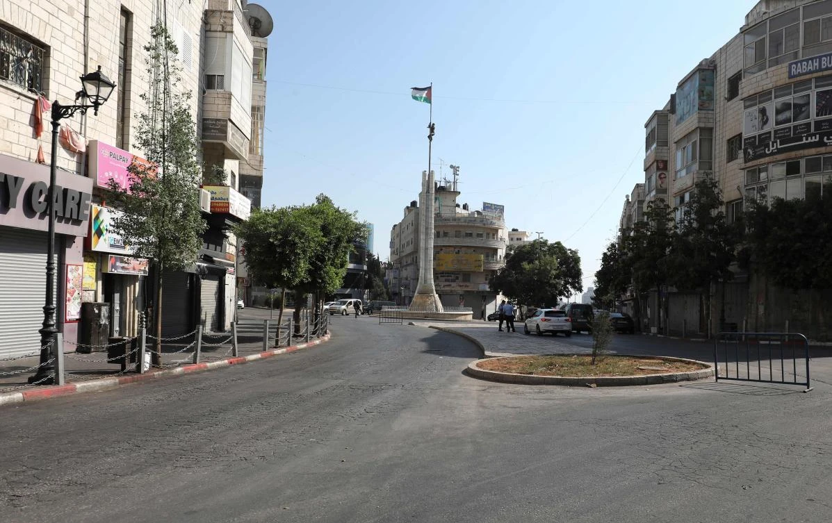 Shops are shuttered along an empty street in the occupied West Bank city of Ramallah on July 6, 2020, amid the ongoing novel coronavirus pandemic crisis. (AFP)