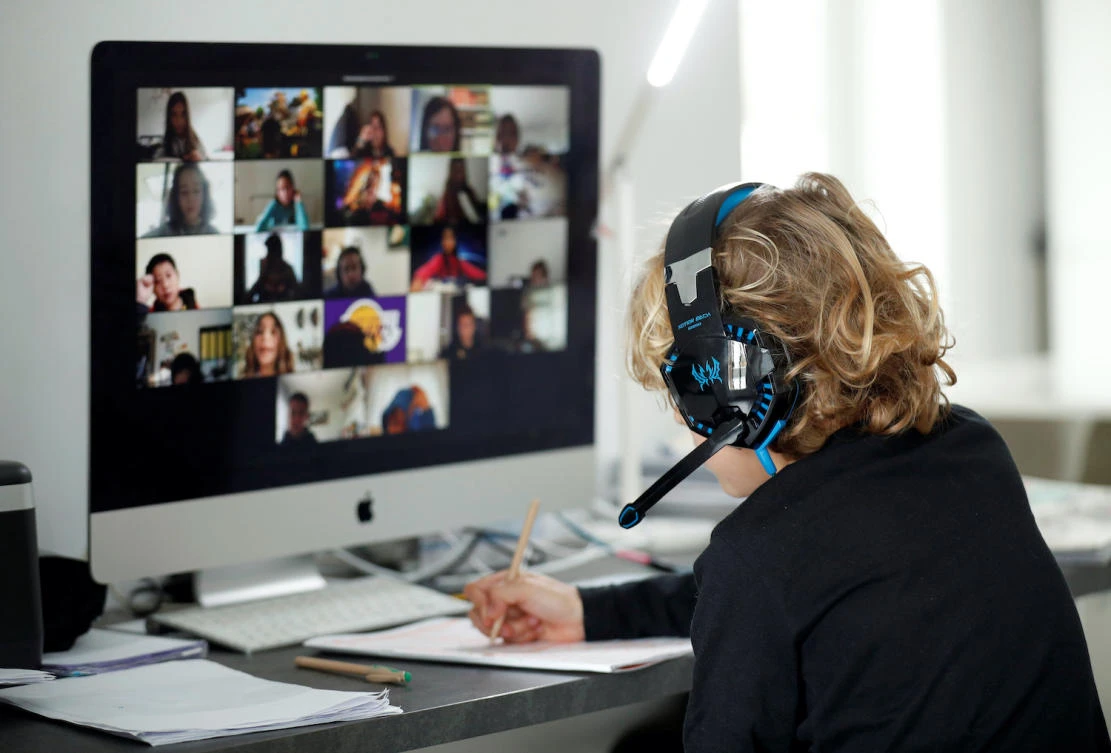A student takes classes online with his companions using Zoom at home in El Masnou, north of Barcelona, Spain. (Reuters)