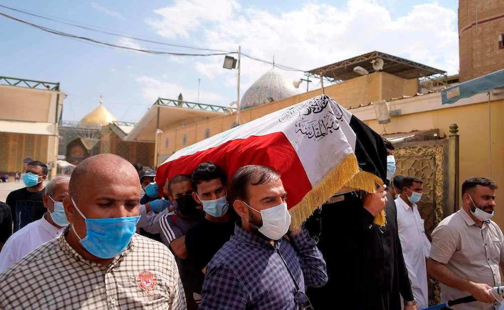 Iraqis mourn expert on armed groups killed by unknown gunmen