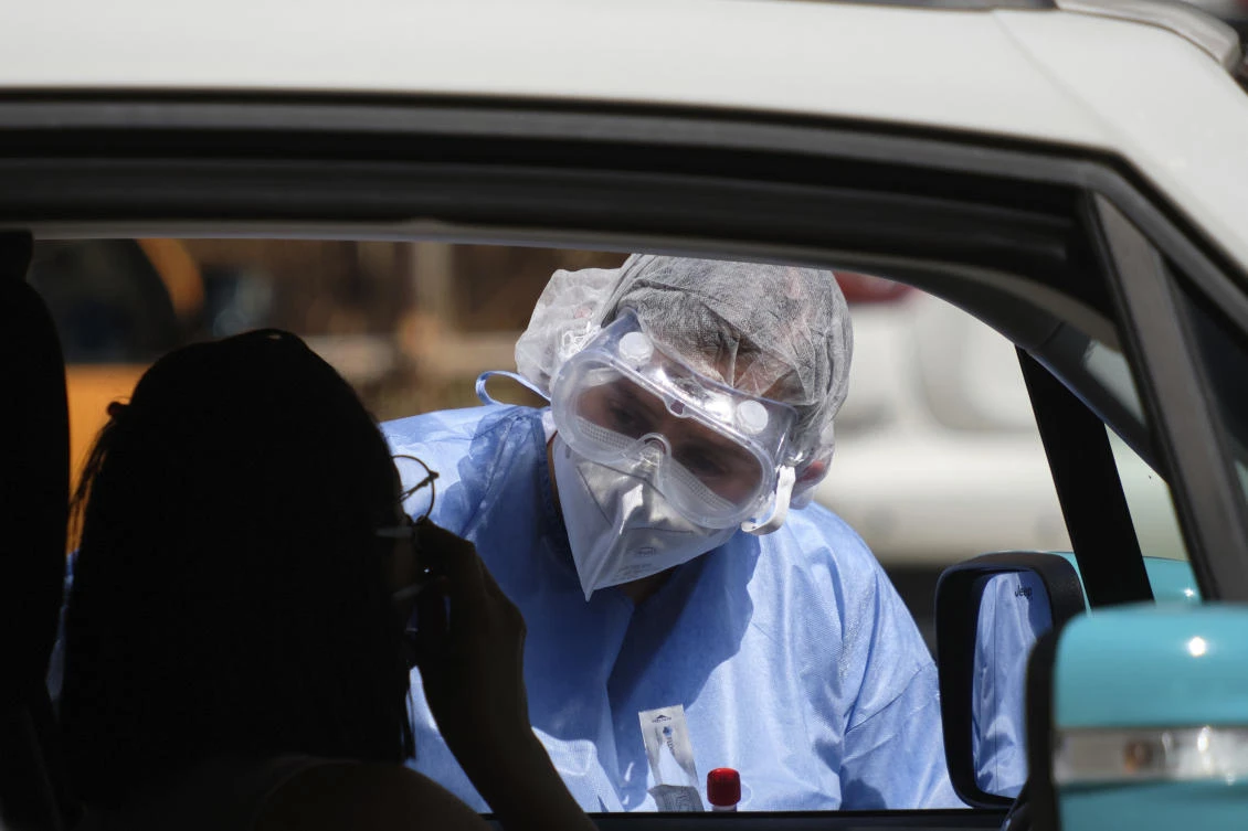 A medic takes swabs for COVID-19, in Rome, July 6, 2020. Public health authorities are urging Rome’s community of immigrants from Bangladesh to voluntarily be tested for COVID-19. (AP Photo)