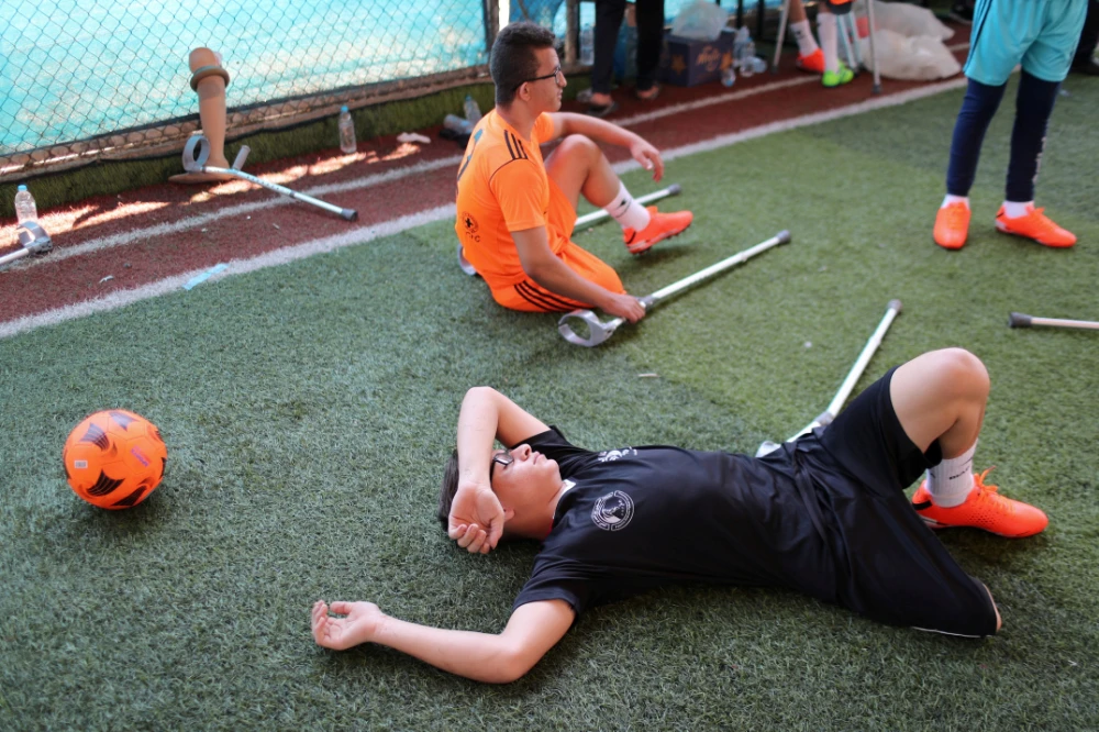 Amputees rest during a soccer training session in Gaza. (Reuters)