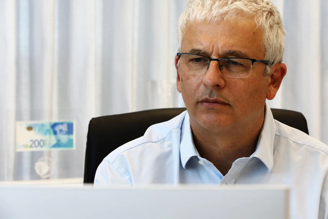 Bank of Israel Deputy Governor Andrew Abir poses for a picture in his office in Jerusalem July 8, 2020. (Reuters)